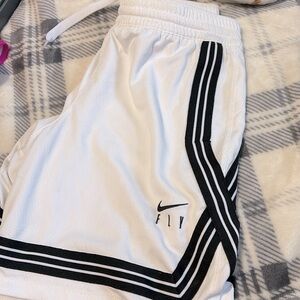 White Nike basketball shorts.